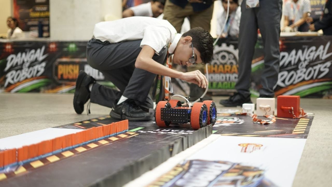 A student setting up a robot on the Robo-Pull track